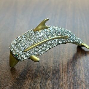 Elegant Gold and Rhinestone Dolphin Shoulder Brooch with emerald eyes.
